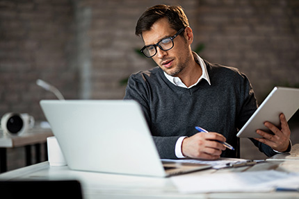 Man working at his desk with laptop and notepad