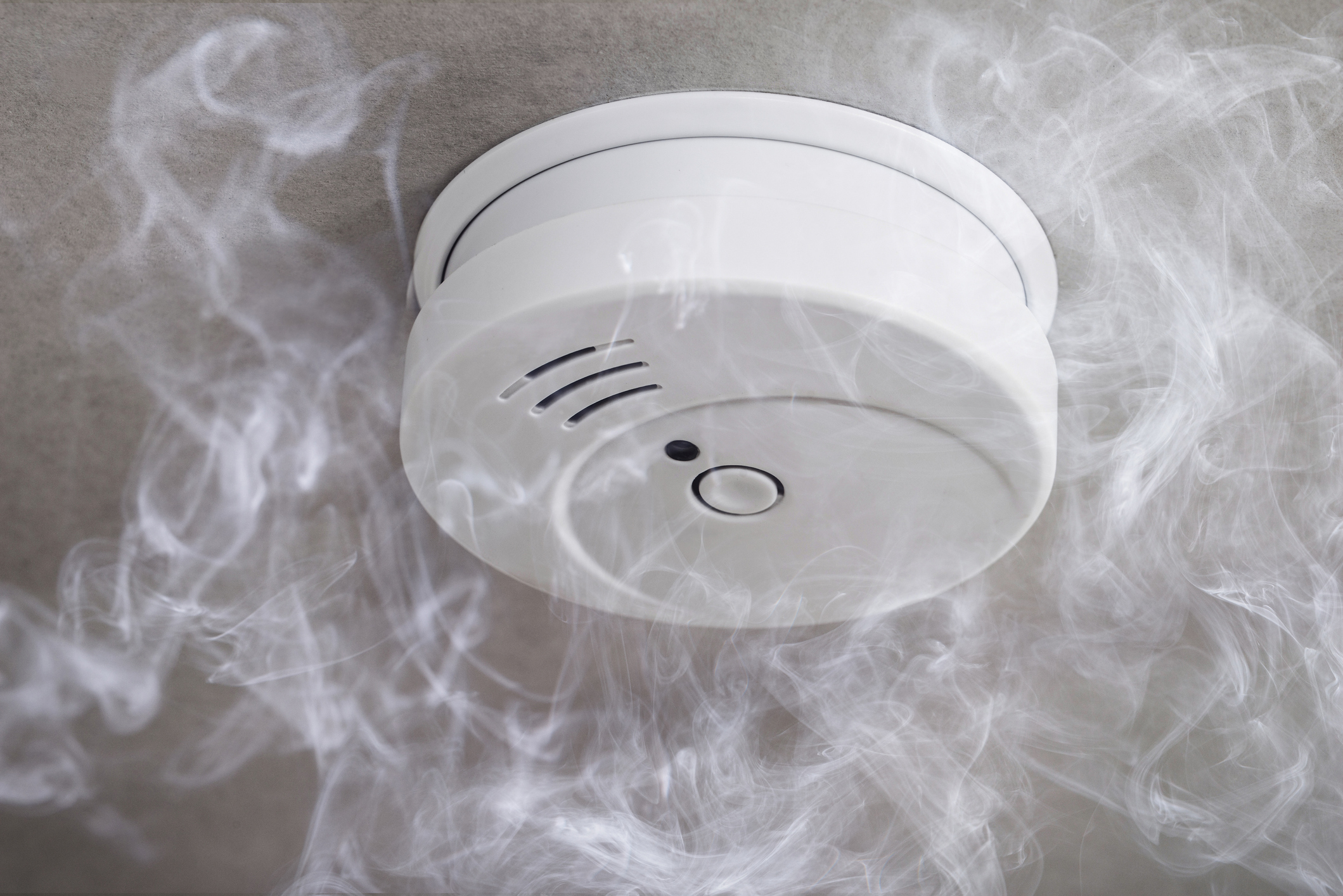 Close-up of white smoke detector on a ceiling